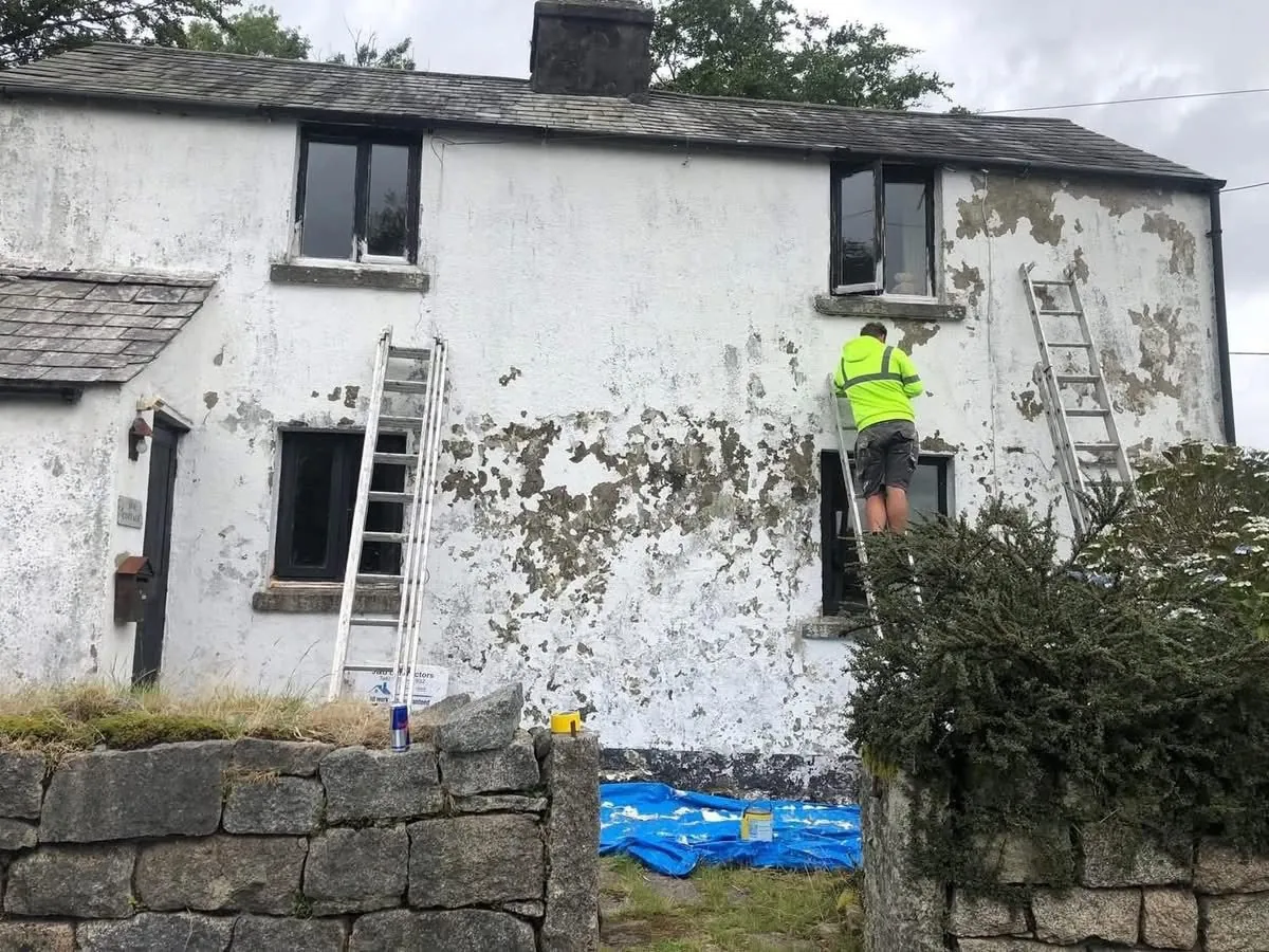 Cottage with blown, flaking render before repair in Perranporth